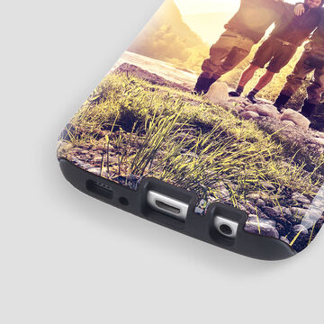 The phone is printed with a photo of friends at the beach, radiating joy.