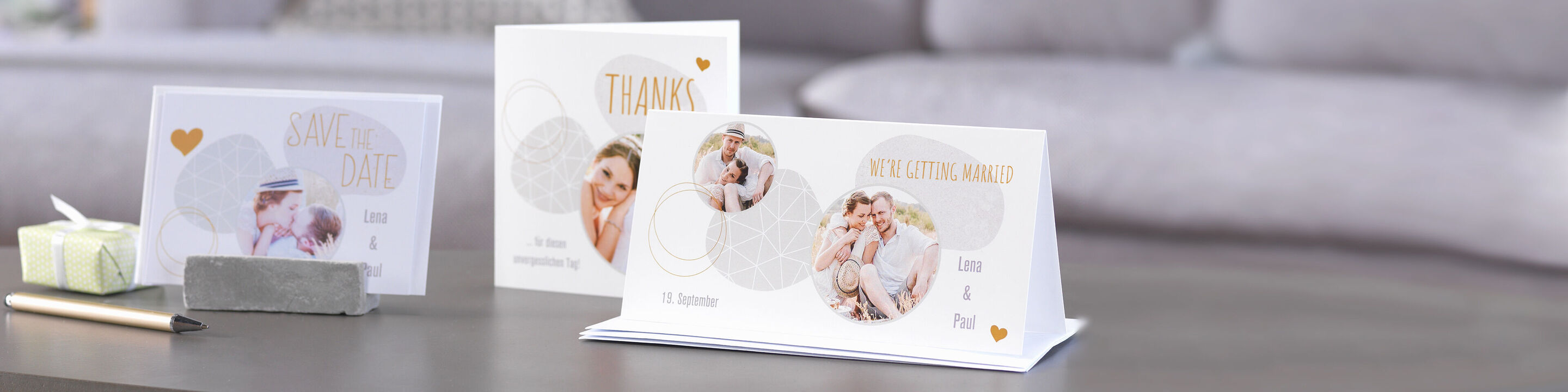 Three lovingly designed CEWE greeting cards with thank you messages and photos of happy moments on a table.