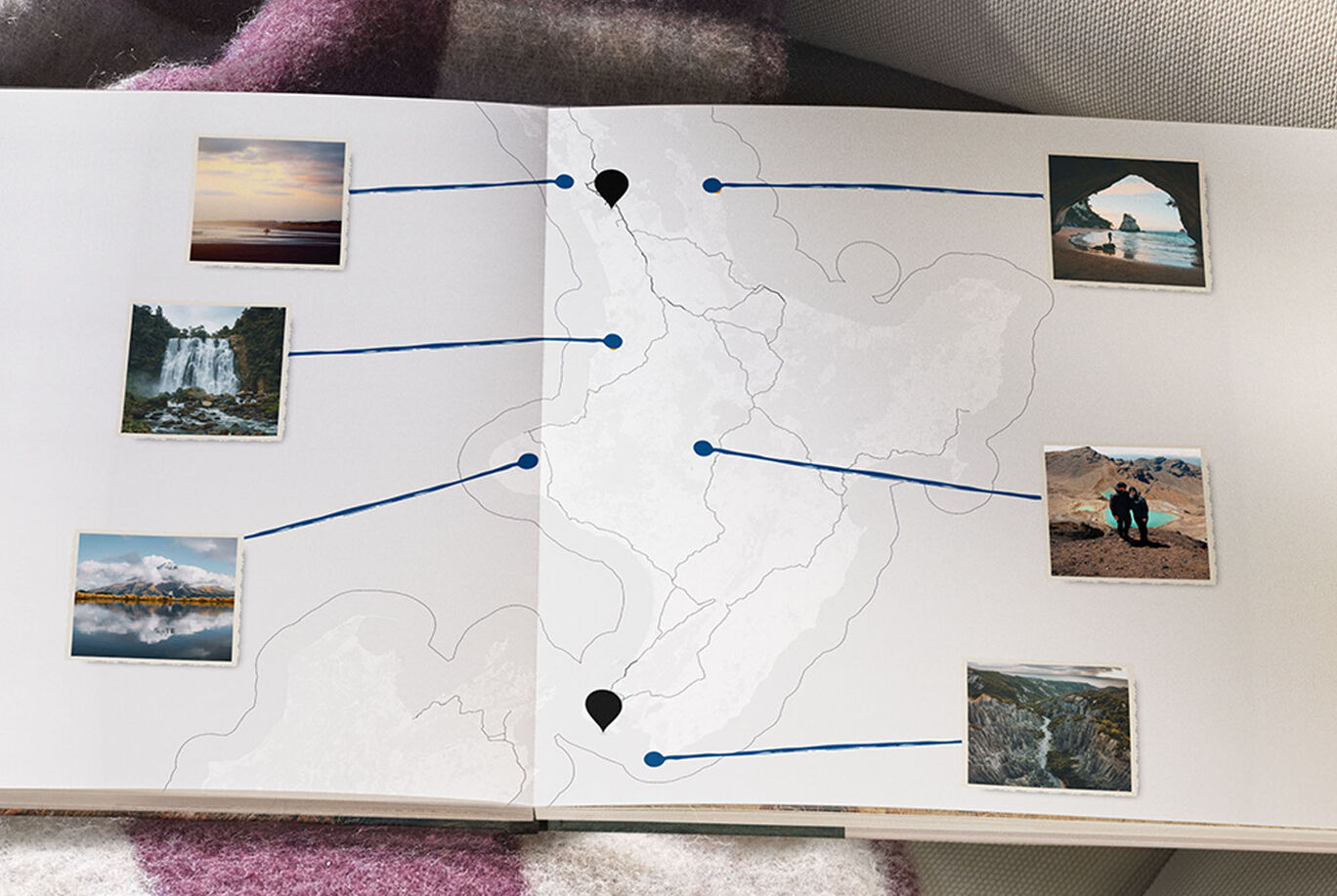 Open CEWE photo book with photos from travels and map markers.