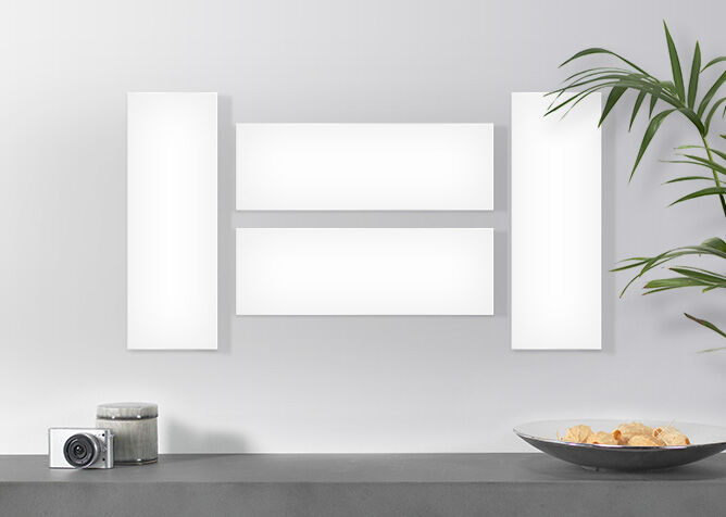 Wall art in various sizes, with a plant vase and a camera beside it