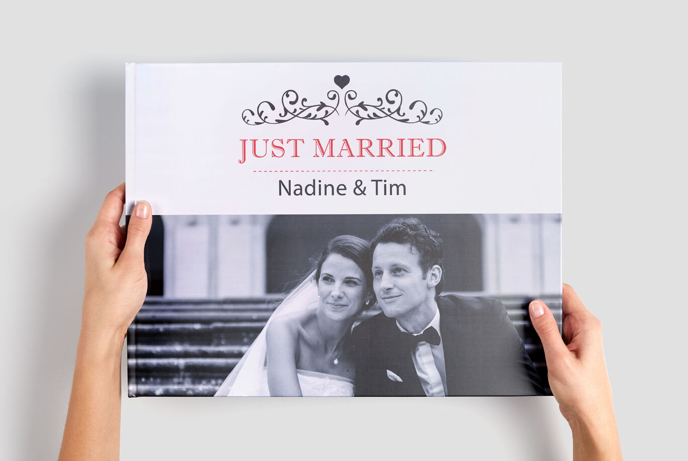 People hold a CEWE photo book titled 'JUST MARRIED'