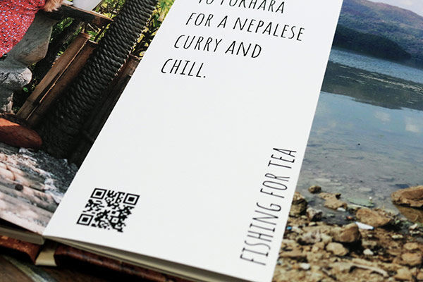 Page of a recipe in a photo book with a QR code for a Nepalese curry. Title is 'Fishing for Tea'.
