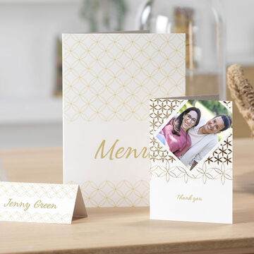 Elegant invitation cards and menu cards on a table for a celebration.