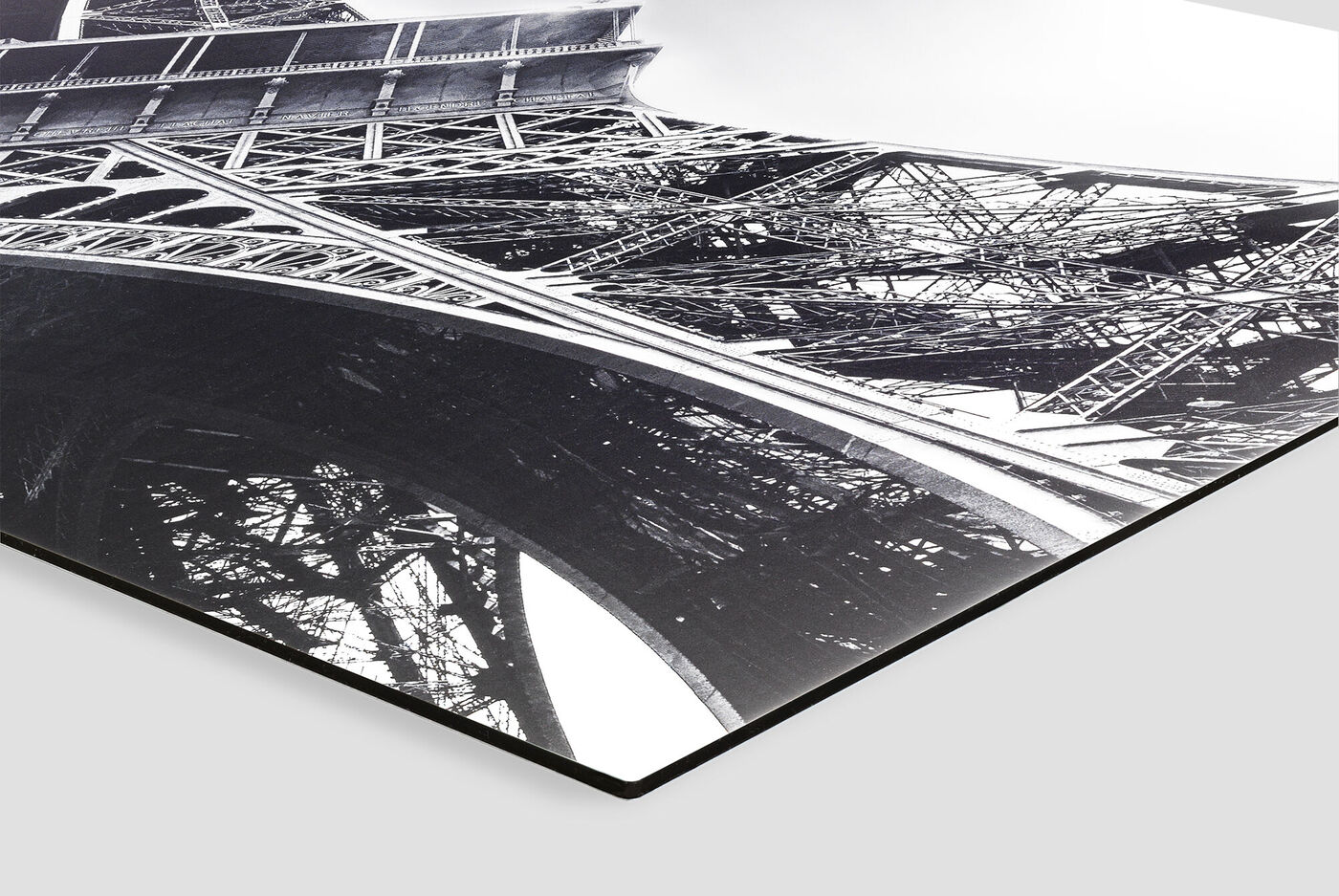 Close-up of the Eiffel Tower's understructure in black and white.