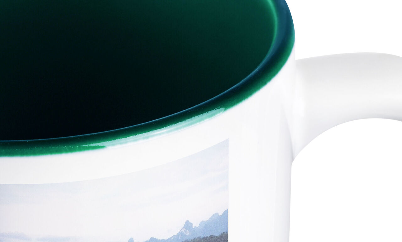 Detail view of a mug with a photo of mountains.