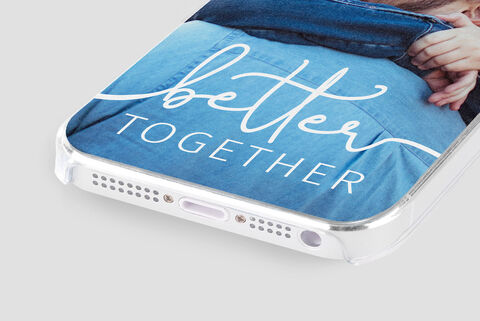 Person in blue jeans holding a smartphone with a personalized cover saying 'better together'