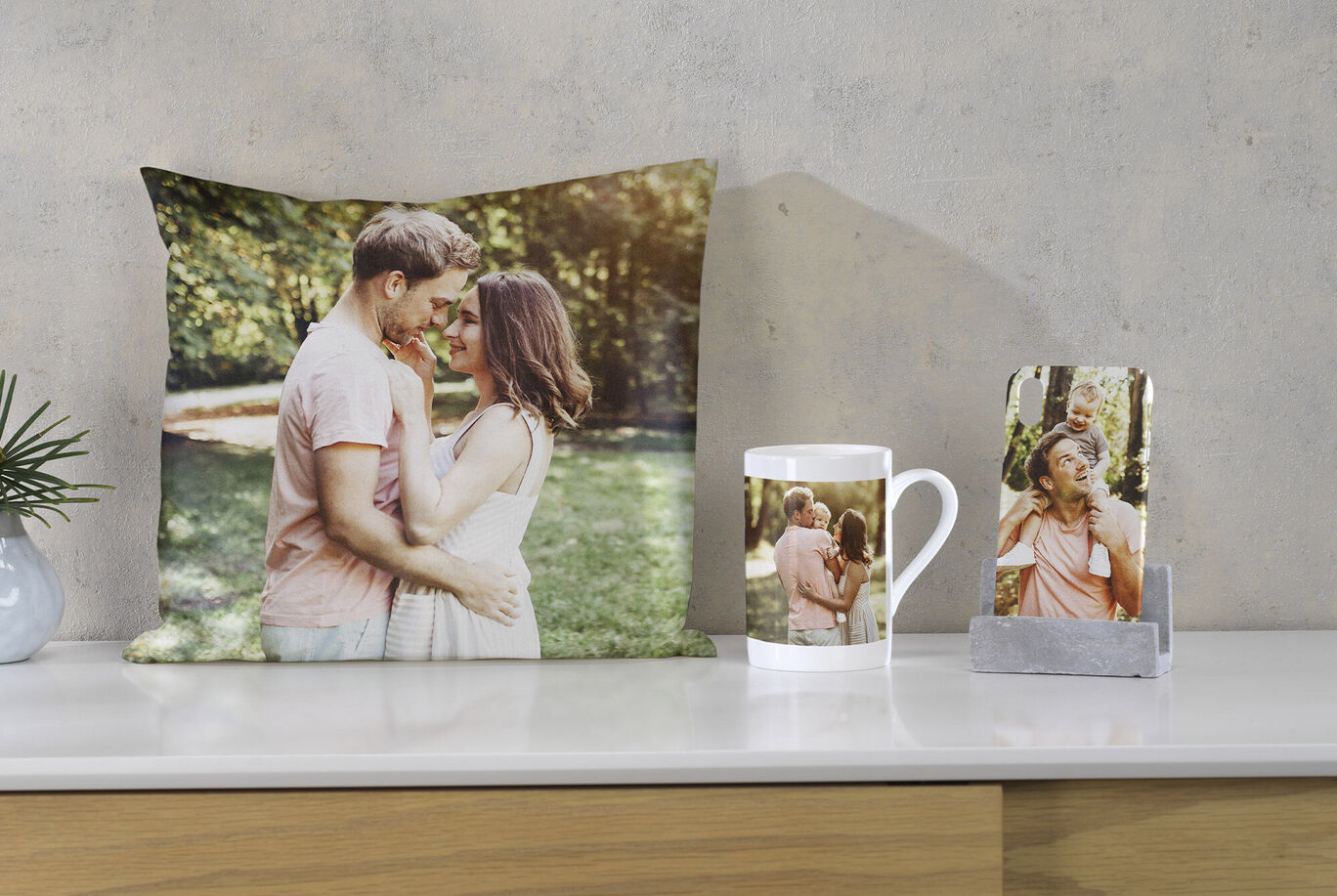 A pillow, mug, and card with a romantic image of a couple outdoors