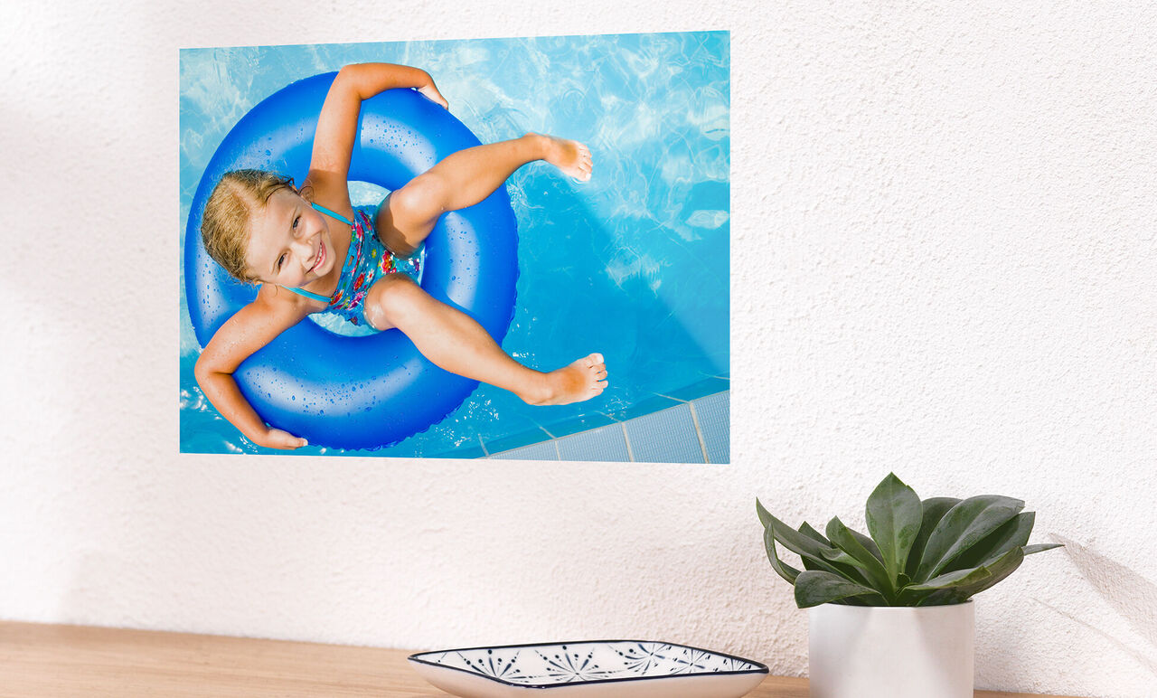 A cheerful child with a swim ring in the pool having fun