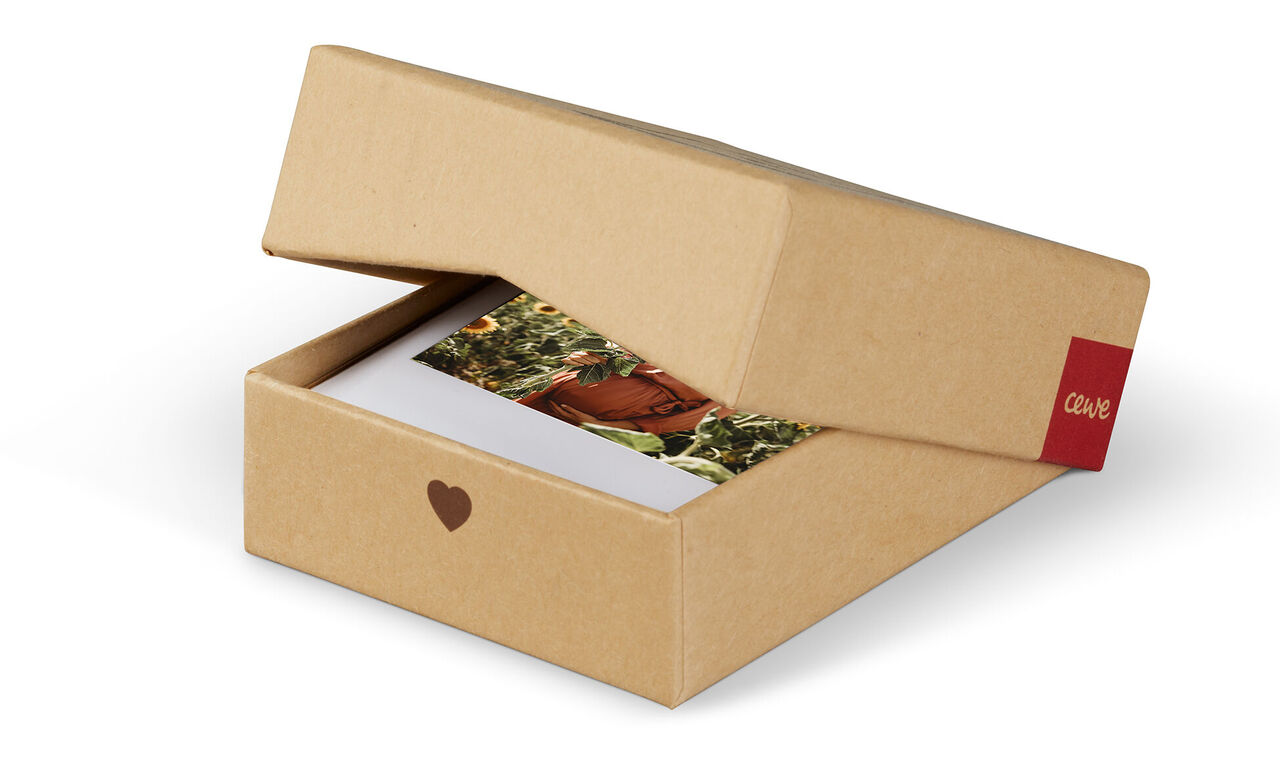 A lovingly designed CEWE box with photo motifs, opened to show a heart motif.