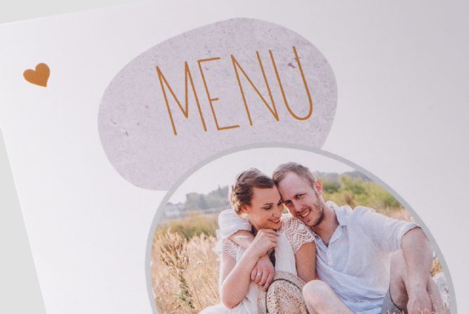 A lovely menu card with a heart design showing a happy couple in a summer landscape