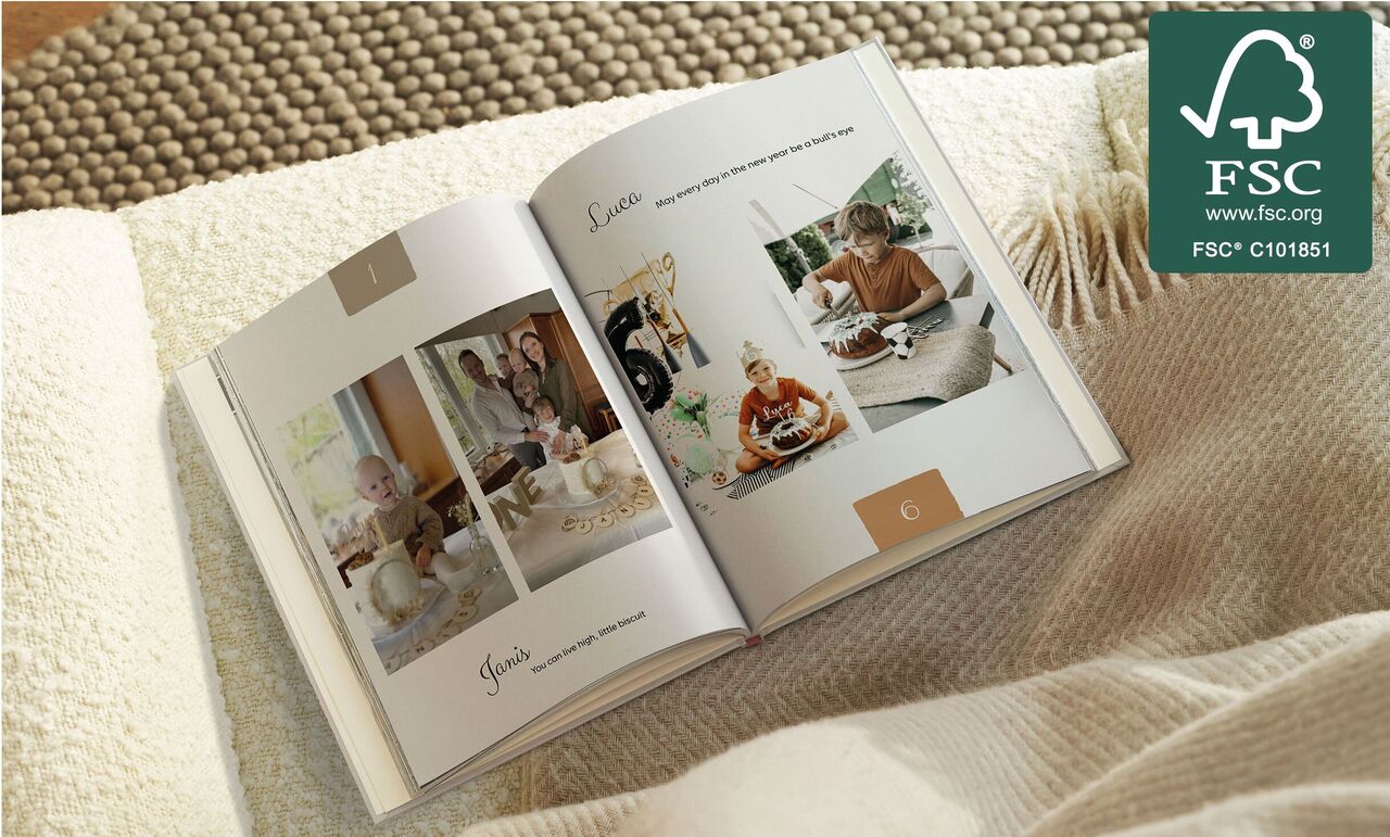 Open photo book with pages full of personal memories and family celebration photos, CEWE photo book