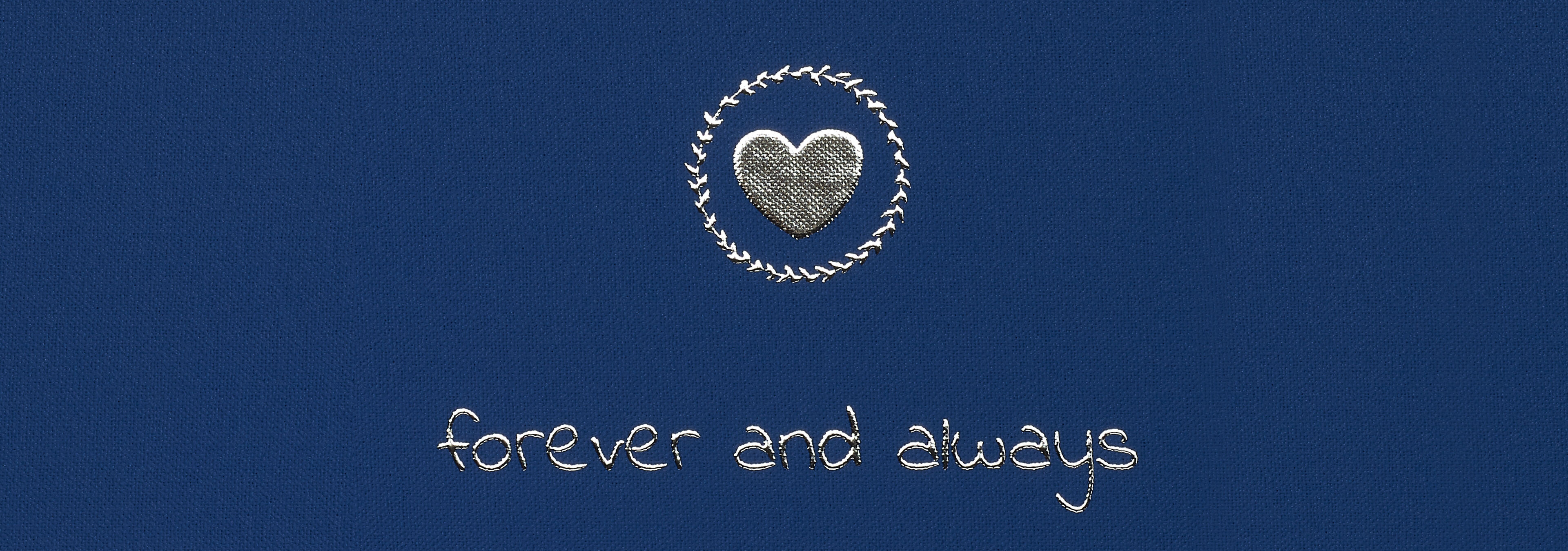 An embroidered heart in a circle with the text "forever and always" below.