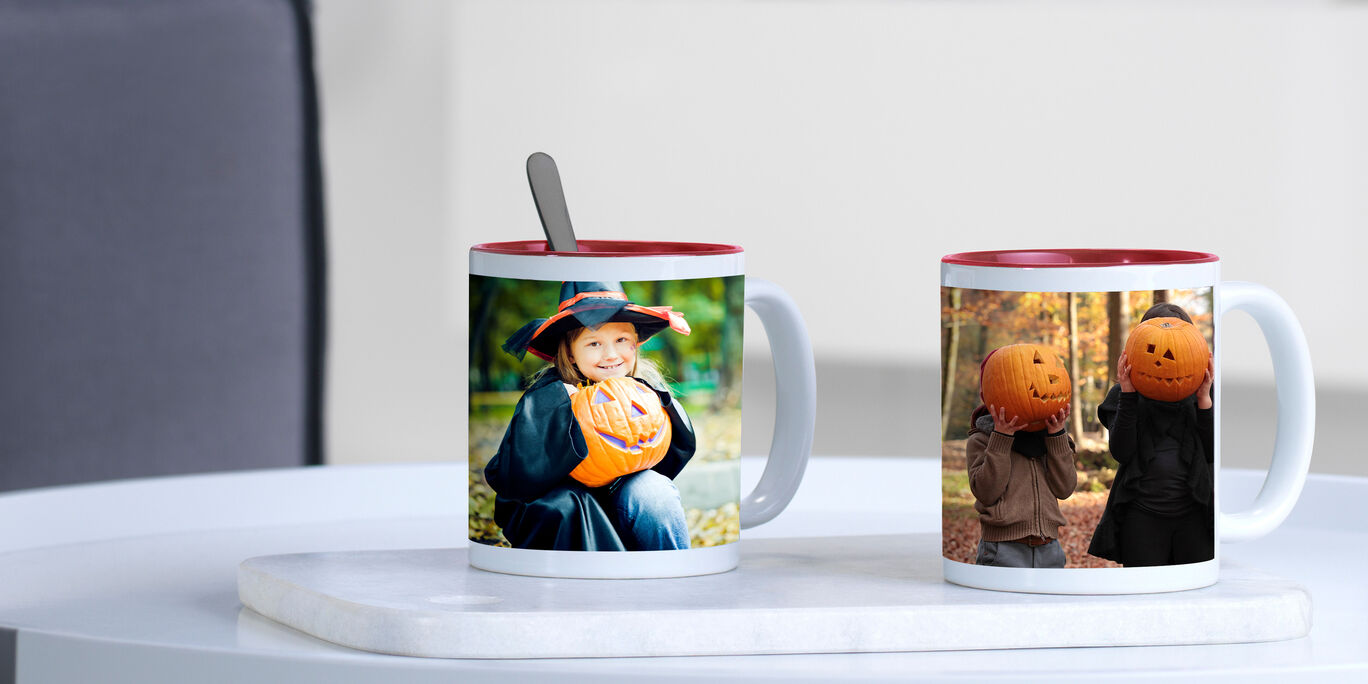 Two colorful mugs with spoons, one with a child and a pumpkin, the other with friends and pumpkin heads. Perfect for Halloween.