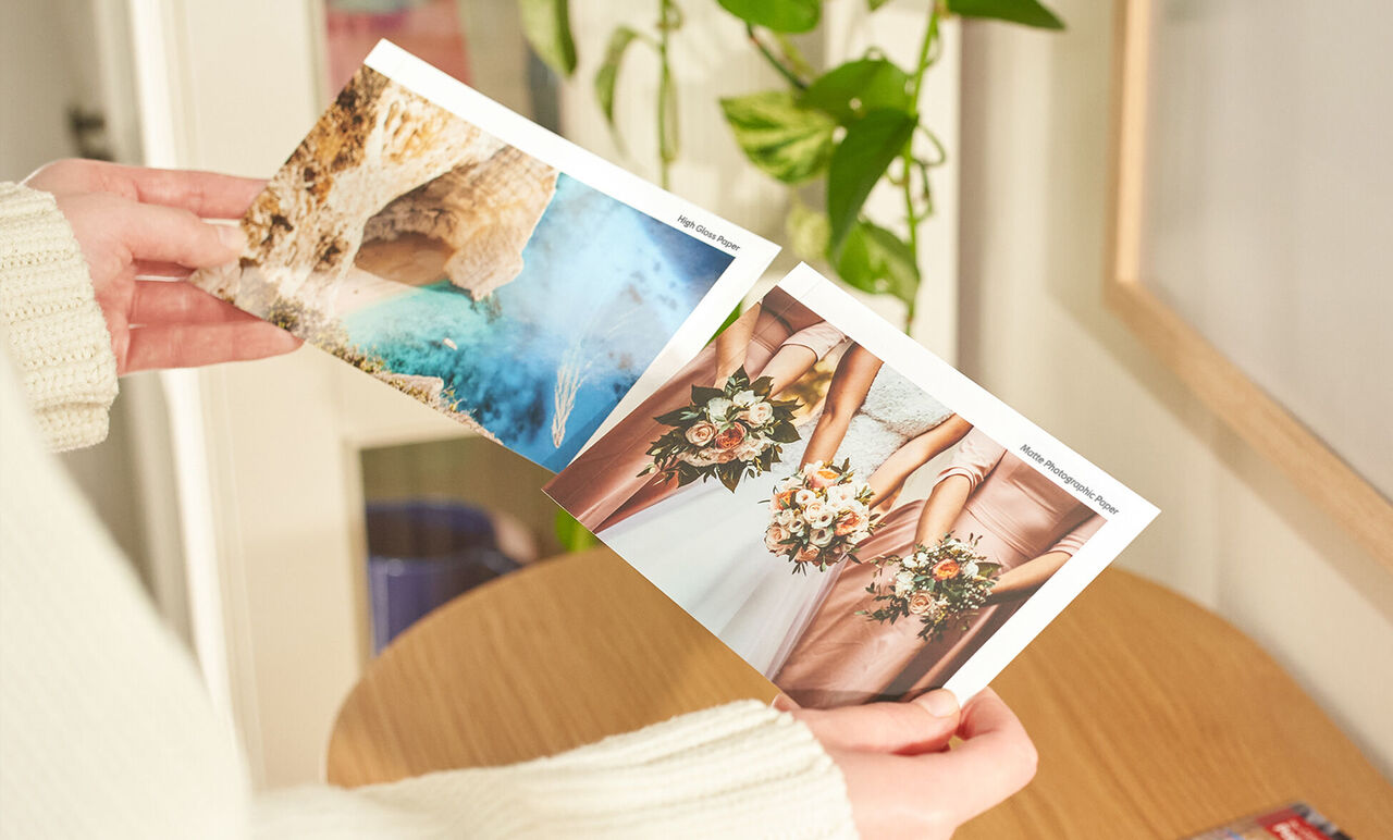 Two photos in a person's hands showing a coastal landscape and wedding bouquets. Joyful memories are shared