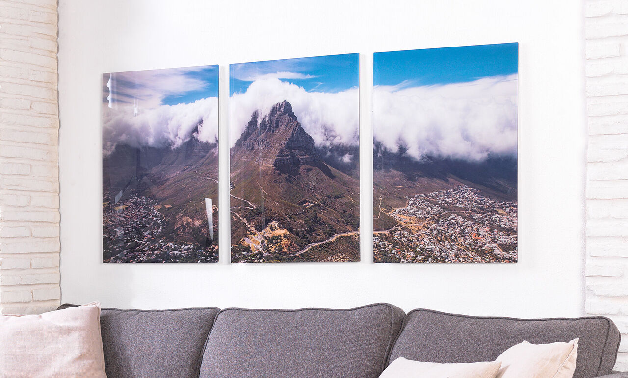 Three connected images of a mountainous landscape overview with clouds in the background.