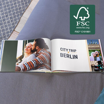 An opened photo book with pictures from a city trip to Berlin.
