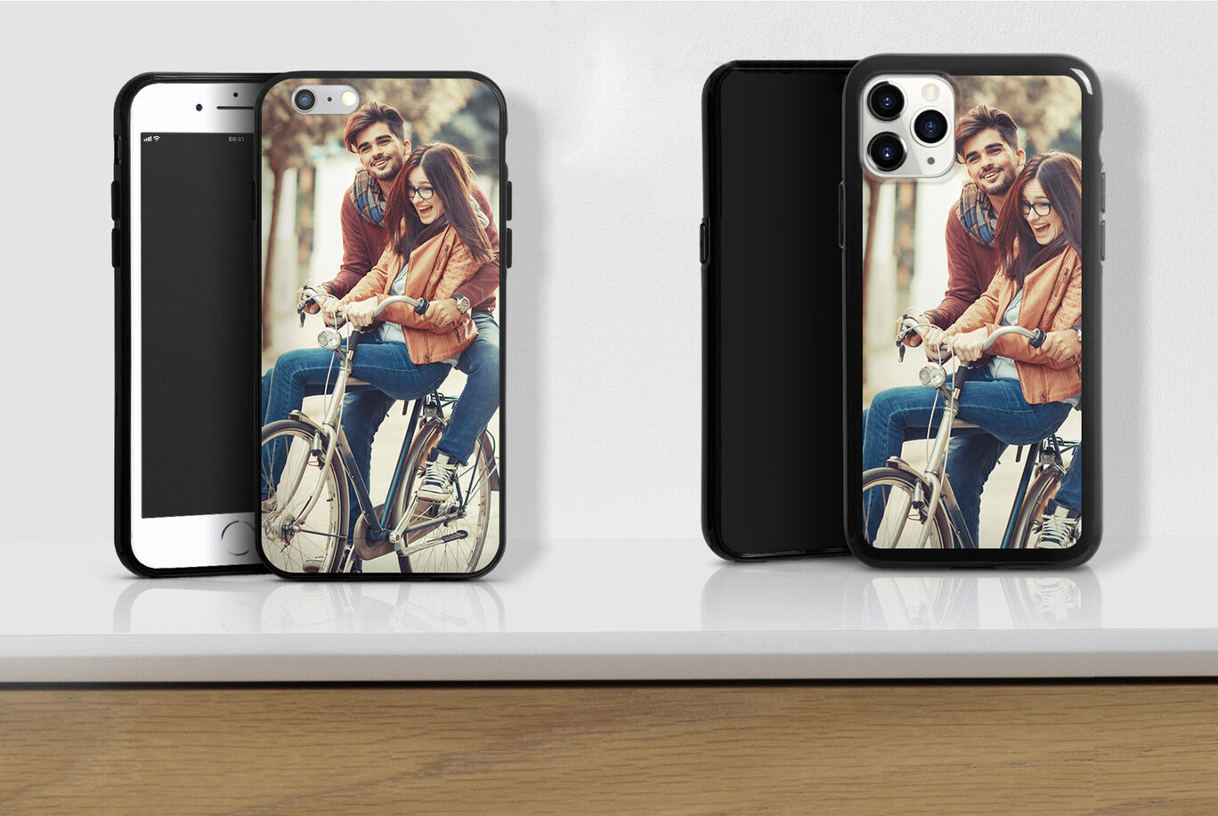 Two handmade phone cases with photos of a happy couple on a bicycle