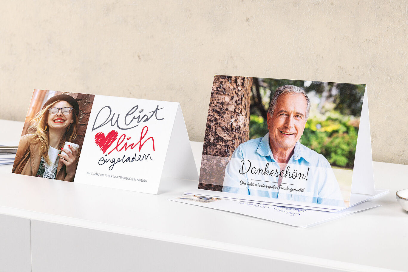 Two lovingly designed cards on a table: an invitation card and a thank-you card.