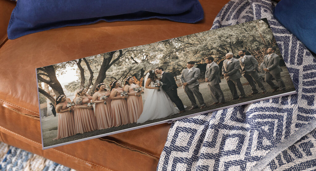 Wedding couple with witnesses outdoors, standing in front of beautiful trees.