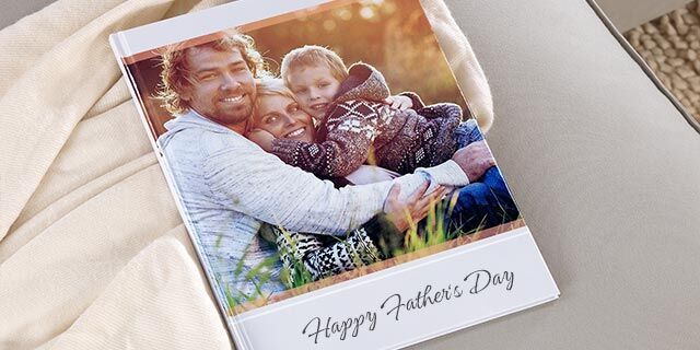 Family hugs with a photo book for Father's Day.