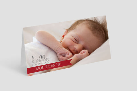Creative greeting card with a baby arm and the loving text 'Hello Moritz Leander'.