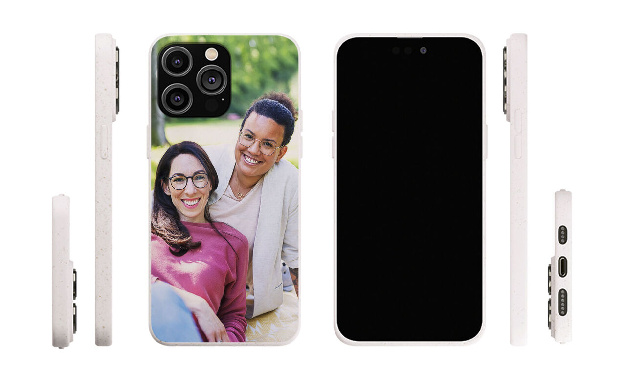 A phone with a personalized design shows a happy snapshot of a couple outdoors.
