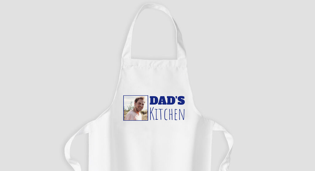 White apron with blue text and an image of a father.