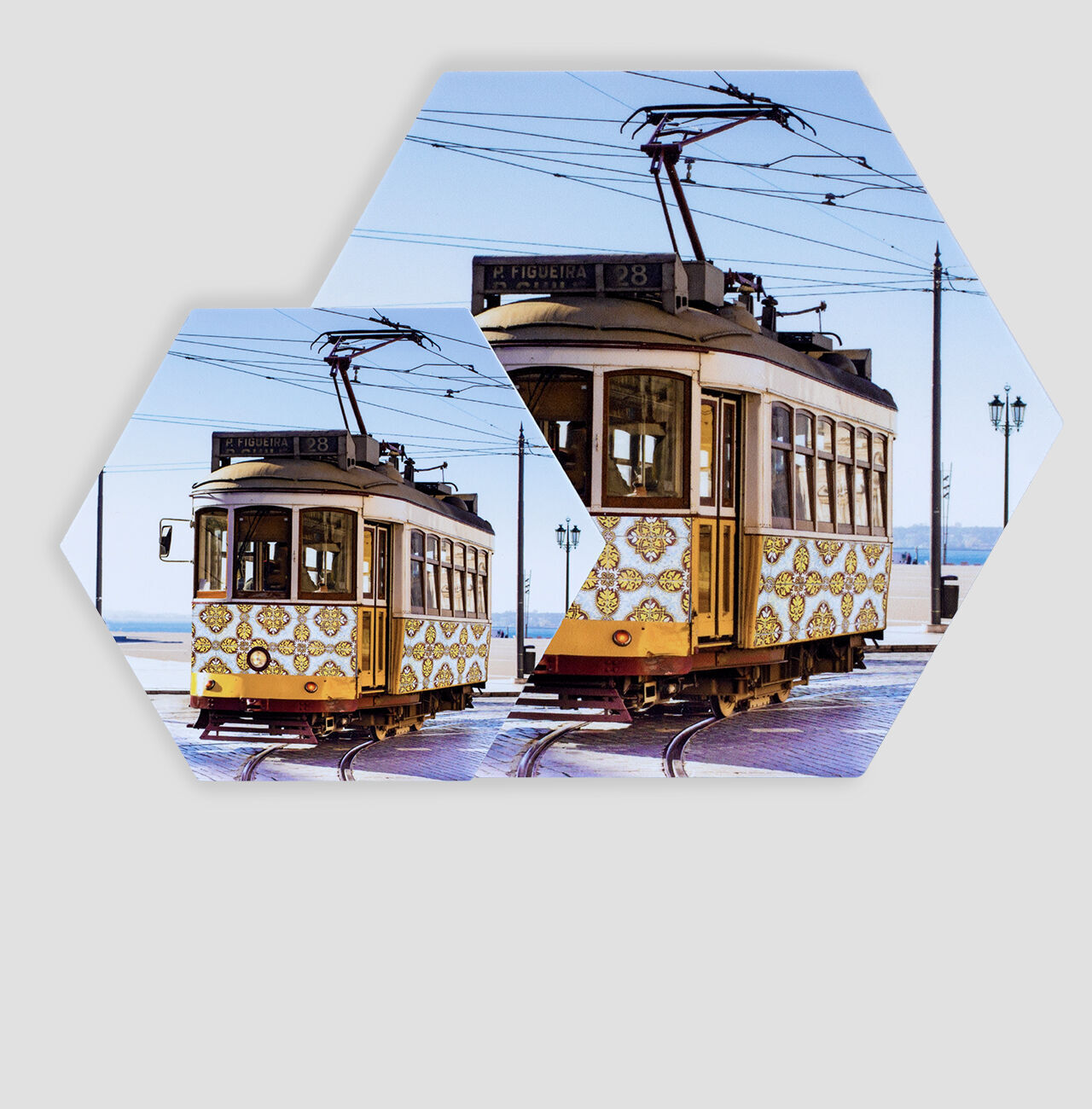Colorful tram with floral design in the sun, standing on tracks.