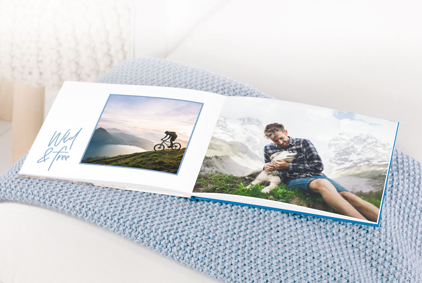 An open photo book with pictures of a cyclist in nature and a man holding his dog in his lap.