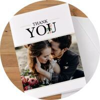 A thank you card with two people and flowers in the foreground, standing lovingly together