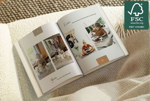 Open photo book on a table, with loving family photos sharing memories.