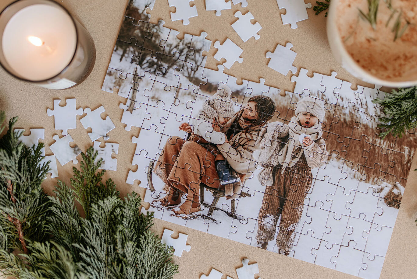 A beautiful puzzle shows a mother with her child in the snow, surrounded by pine branches and a candle.