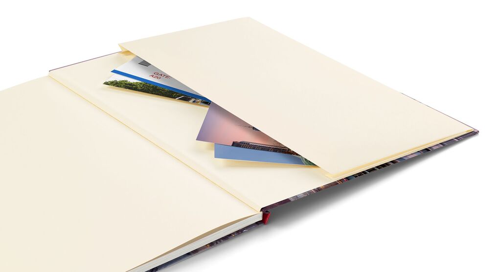 An open photo book with blank pages and photos sticking out.