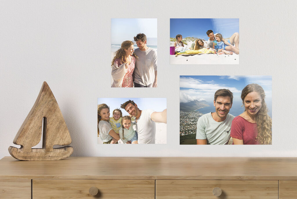 Four cheerful pictures on a wall capturing family holiday memories