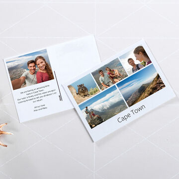 An open photo book with memories from Cape Town showcasing vacation photos and happy moments