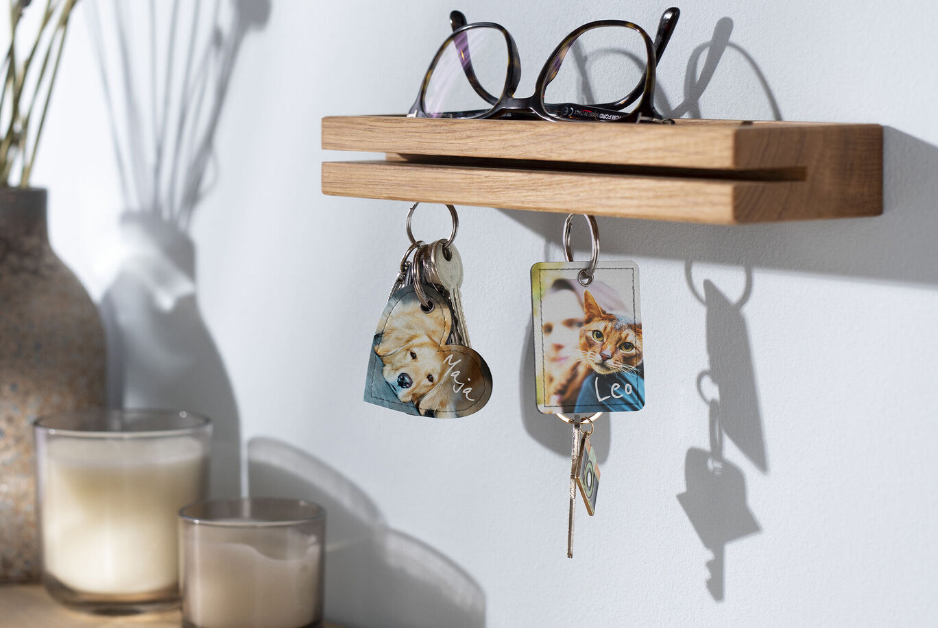 A wooden key holder with glasses and animal photographs.