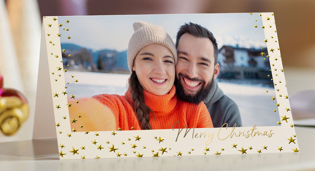 A festive greeting card with golden stars and the inscription 'Merry Christmas'.
