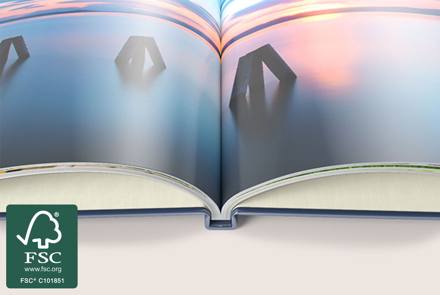 An open page of a CEWE photo book with stylish images of landscapes and wood structures.