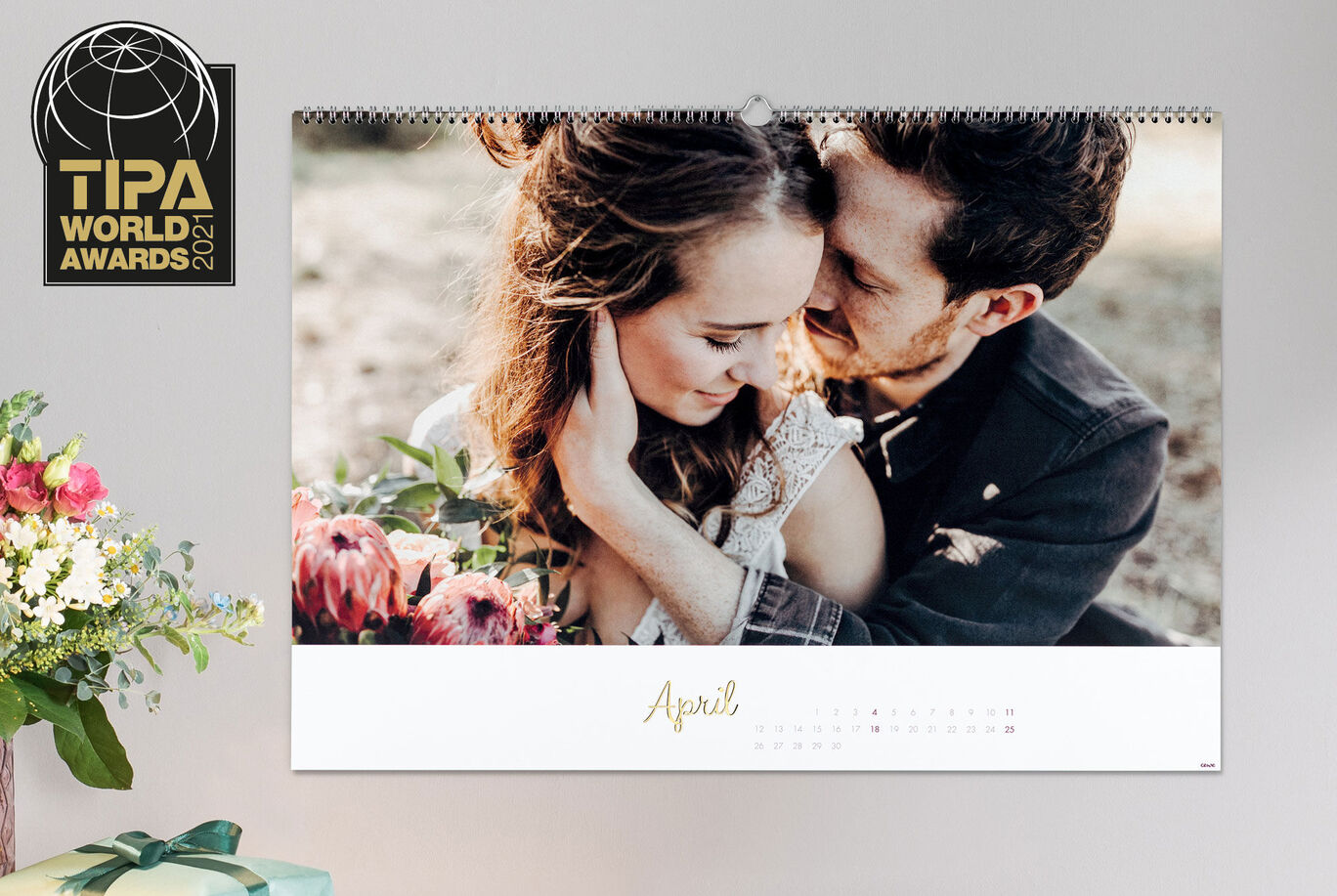 A beautifully designed calendar for April with a romantic picture of two people and colorful flowers.