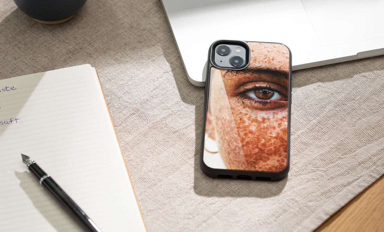 Close-up of a phone with a personalized cover showing a person's face.