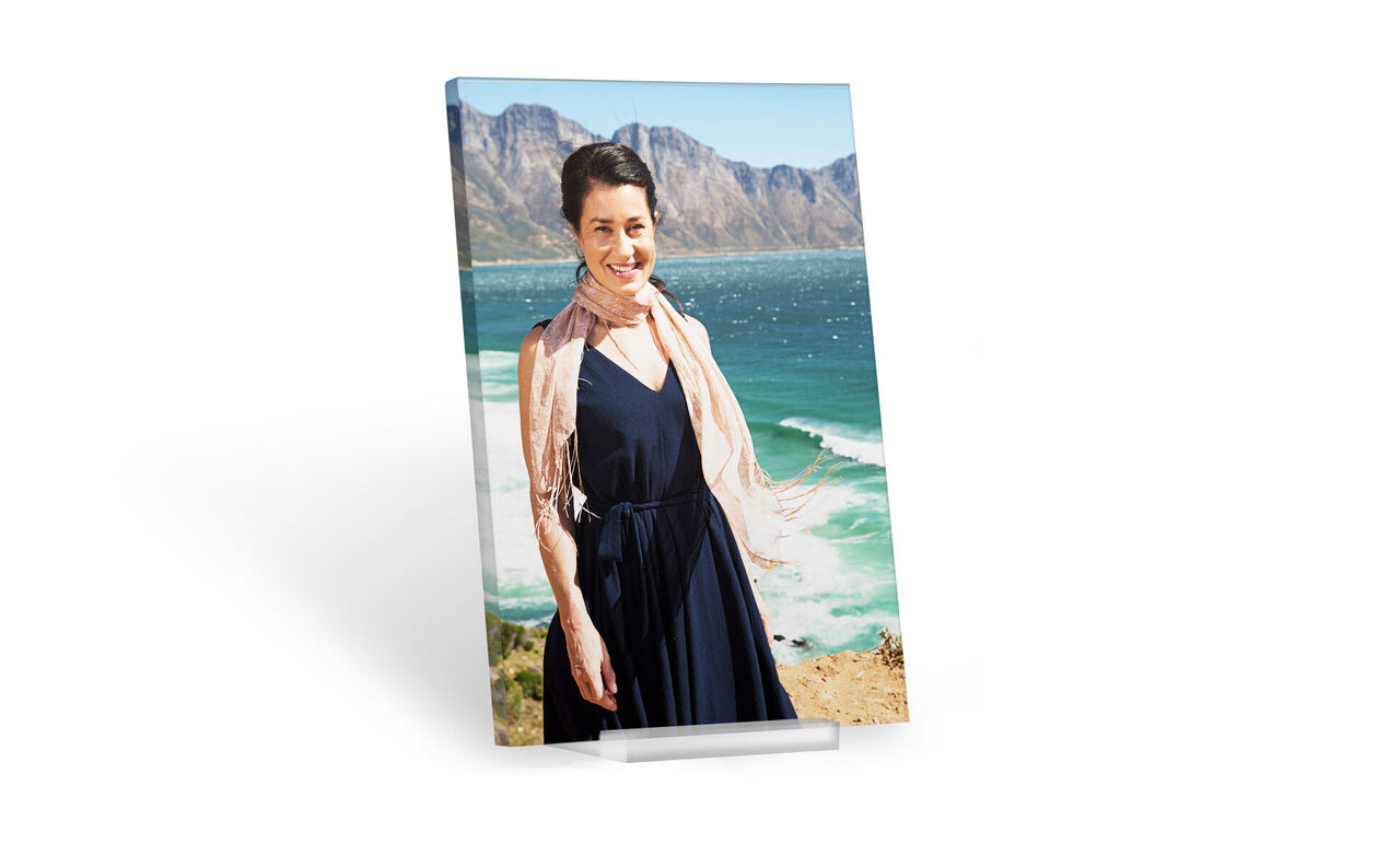 Woman in an elegant dress, surrounded by a beautiful coastal landscape
