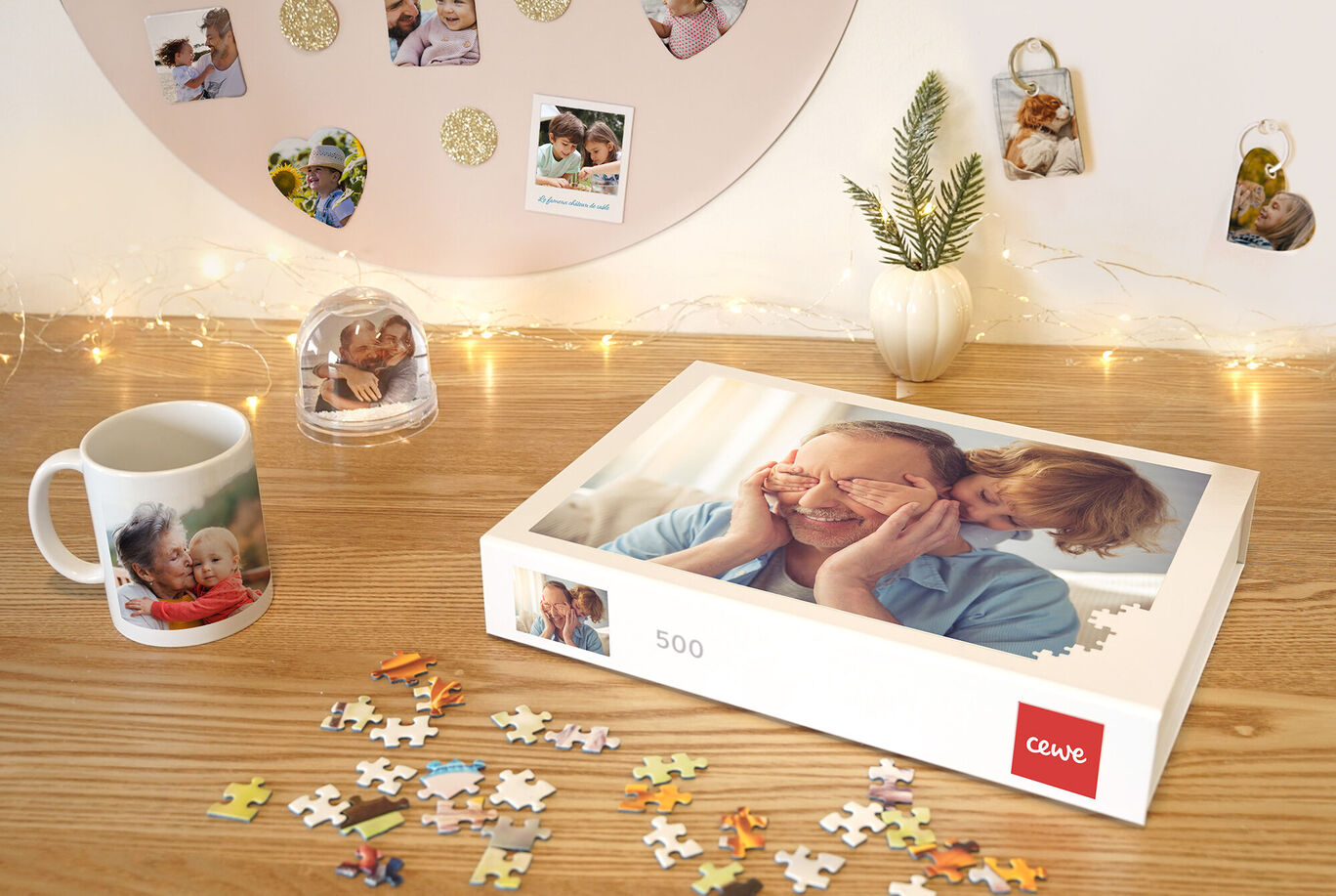 A mother smiles with a child in front of her, who covers her eyes. Puzzle pieces are on the table next to a CEWE photo book.