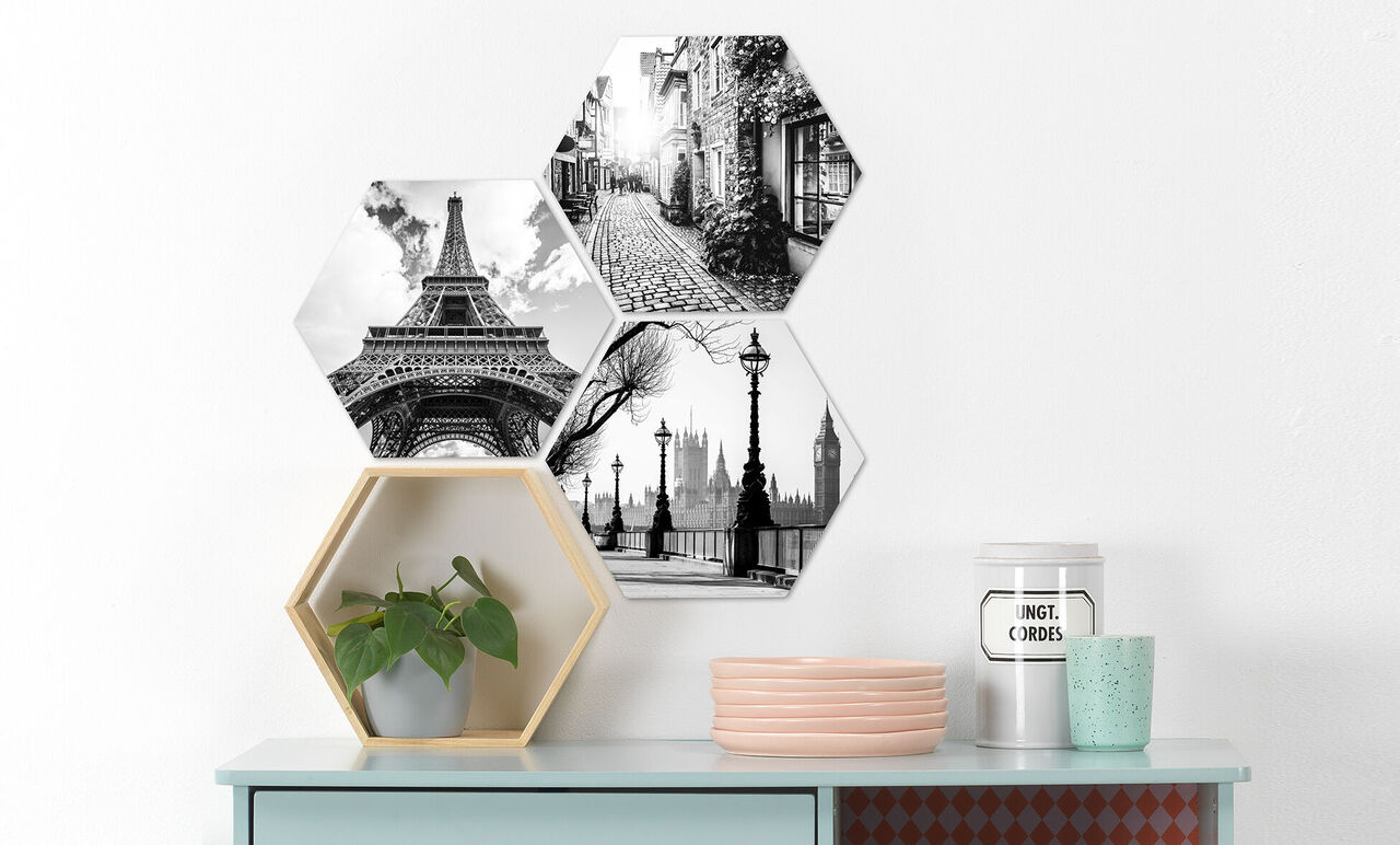 Three hexagonal black-and-white pictures with the landmarks Eiffel Tower, London skyline, and a city street.