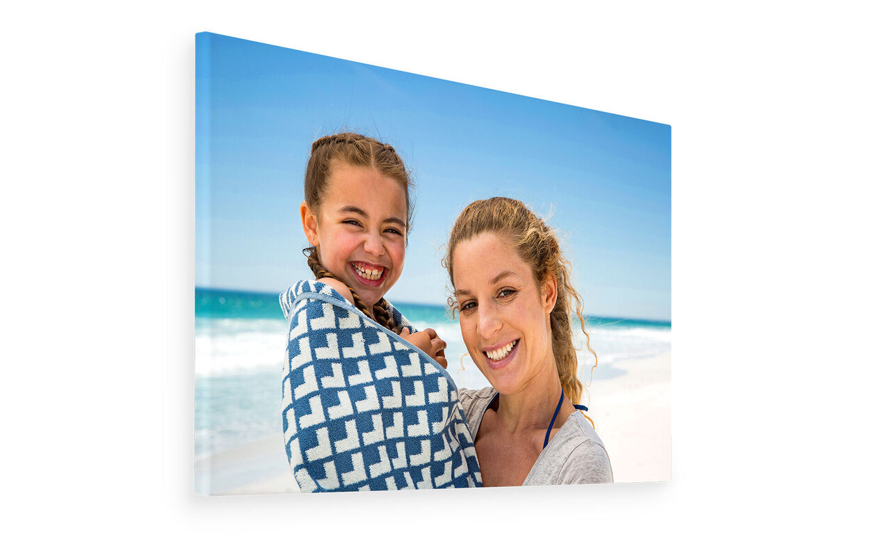Two people at the beach, one wearing a patterned scarf.