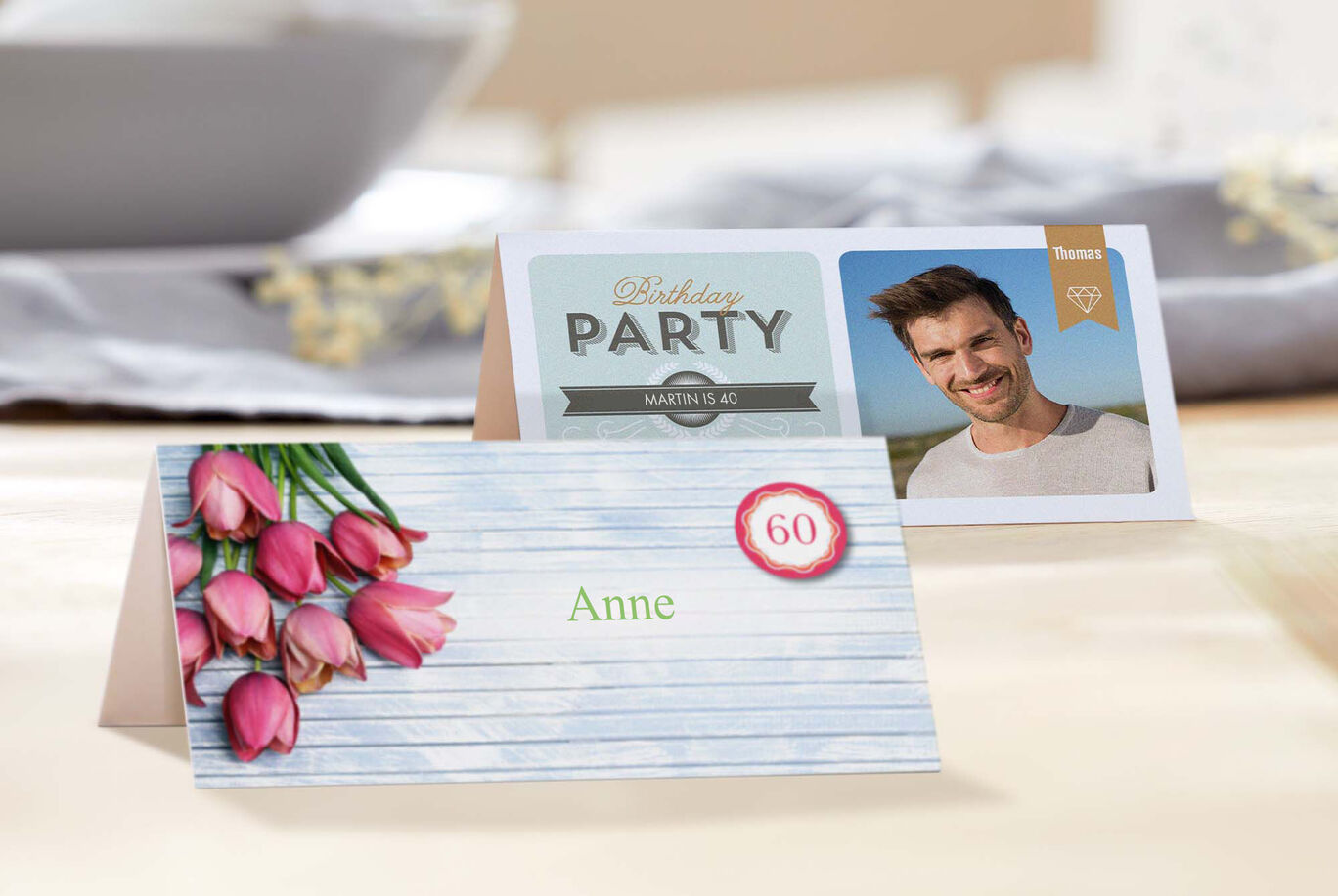 Two festive place cards for a birthday party, one with colorful flowers and the other with a photo and 'Birthday Party'.