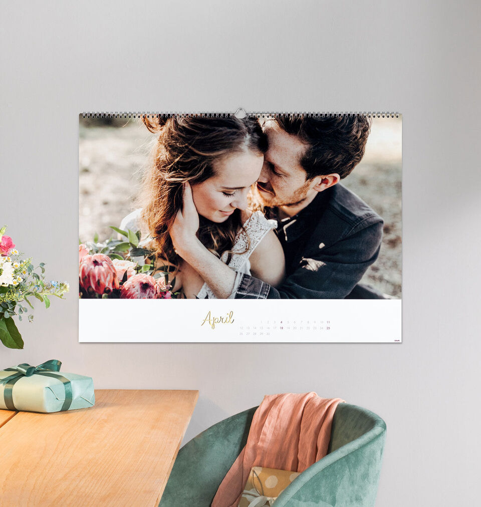 A calendar featuring a romantic couple, hugging and looking happy.