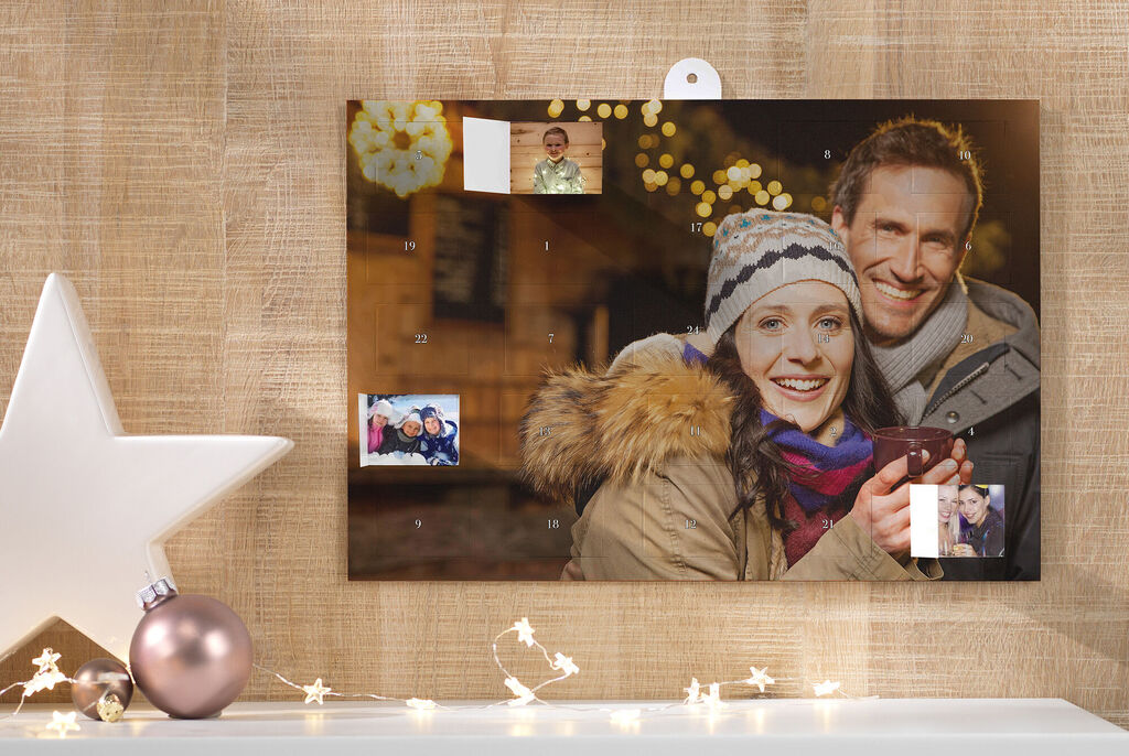A pretty wall picture with several photos showing happy memories under warm lighting.