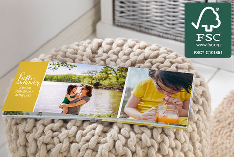 Happy moments in a photo book by the water with a drink.