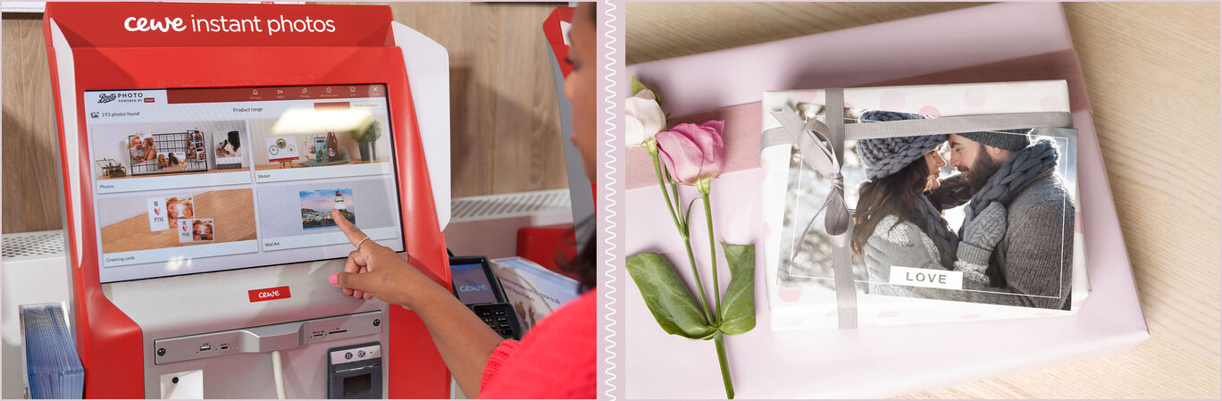 A person touches the screen of a photo booth to select photos. Various photo products are visible in the background.