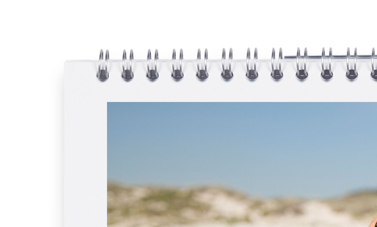 An open photo book with beautiful memories from a beach vacation.